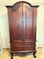 full view of armoire showing doors, drawers, legs
