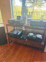 Stereo components, CDs and wood console table overview