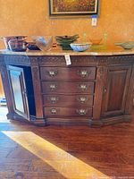 Front view of mahogany buffet with marble top, showing drawers, cabinet doors and hardware