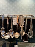 Full view of eight hanging utensils and rack