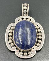 Front view showing lapis lazuli cabochon and beaded silver frame