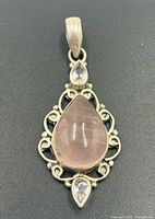 Front view of sterling silver pendant with rose quartz and clear accent stones