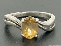 Top view of sterling silver ring showing oval citrine in four-prong setting