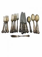 Full set laid out: forks, knives, spoons, butter spreader