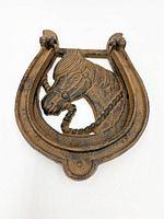 Brown cast iron horse head horseshoe door knocker closed