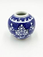 Front view of miniature blue and white ginger jar showing floral motif