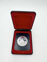 Coin in open display case, full view