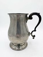 Side view of pewter baluster tankard showing overall form and handle