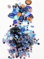 Pile of assorted glass beads, various colors and shapes