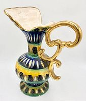 Full side view of multicolour glazed ewer with gilt handle
