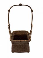 Front view of rectangular bamboo ikebana basket with tall handle