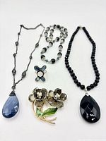 Overall view showing five jewelry pieces