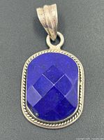 Front view of pendant showing faceted lapis lazuli and rope bezel