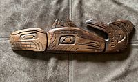 front view of carved wood whale plaque showing design details