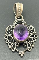 Front view of sterling silver pendant with faceted amethyst