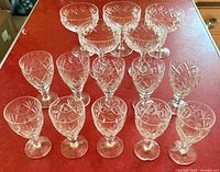Group view of all 15 matching cut-crystal stem glasses