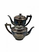 Coffee pot and teapot stacked showing overall form and matching design