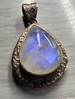Front view of teardrop rainbow moonstone pendant in sterling silver