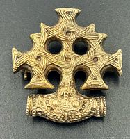 Front view of gold-tone Thor's Hammer brooch showing knotwork design