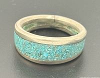 front view of ring showing turquoise chip inlay and metal band