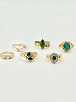 All six yellow gold tone rings arranged on white background