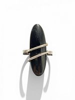 Front view of sterling silver ring with elongated black onyx stone and diagonal bands