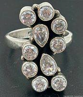 Front view of ring showing vertical cluster of nine clear stones