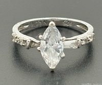 Front view of sterling silver ring with marquise center stone and accent stones