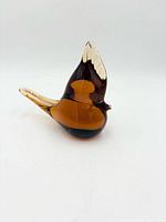 Full view of amber glass bird figurine left side