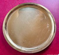 Top view of brass tray showing polished surface and rim