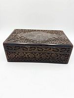 Front and side view showing carved floral panels