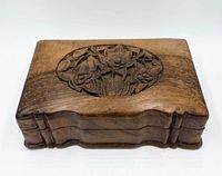Top view showing floral relief carving and wood grain