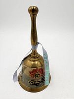 Side view showing floral enamel design and handle