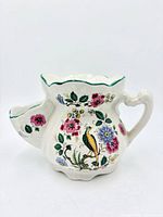 front view of ceramic shaving scuttle mug showing floral and bird design