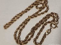 Twisted rope chain laid out showing link pattern and clasp