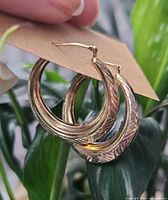 hoop earrings hanging on card showing design