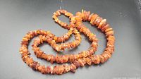 Coiled necklace showing raw cognac amber chips