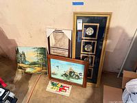 Group shot showing all framed pieces and calendar scroll leaning against wall
