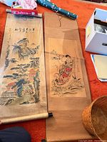 Both scrolls laid out showing complete artworks