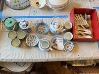 Group shot of all ceramic pieces and soup spoons