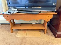 Front view of wooden bench with lower shelf under TV (TV not included)