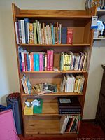 Front view of full wood bookcase with five shelves