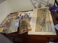 Overall view of six printed items on desk