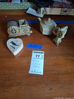 All four carved stone items grouped on table