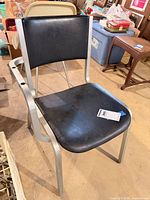 Overall view of chair showing style, upholstery, missing left armrest