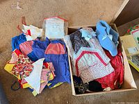 Overview of box with assorted costumes and blue slippers