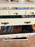 Open dresser drawers showing folded clothing items