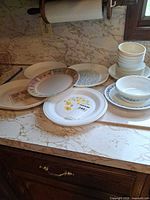 Group of assorted plates, bowls and platter on countertop