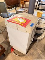 Front left perspective of dehumidifier showing overall form and top controls