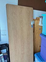 Full view of table top showing wood-grain laminate surface